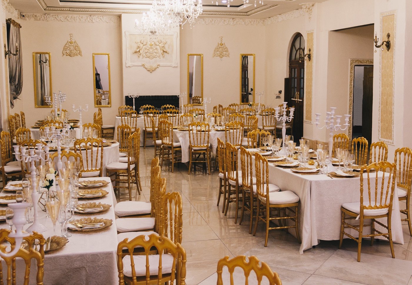 Gold chairs and dressed tables in Selborne Hall